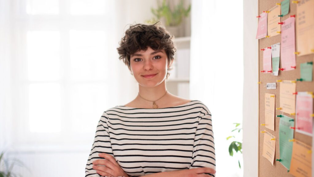 Employment information posted in workplace with young woman
