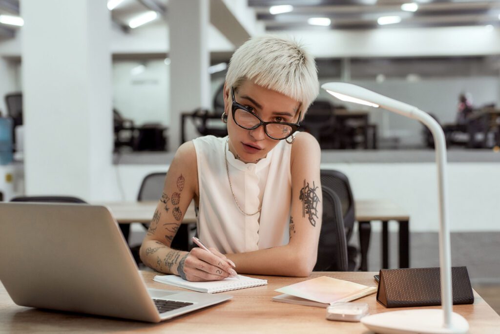 Woman working overtime sitting alone at laptop